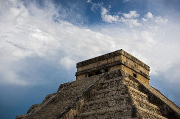 Low angle view of ancient pyramid of Kukulkan against cloudy sky