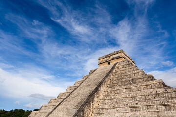 Fototapeta na wymiar Low angle view of ancient pyramid of Kukulkan against cloudy sky