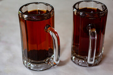 tea lovers' dream: black tea in glass bear mugs (isolated) 