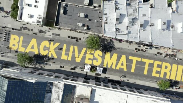 Black Lives Matter aerial over huge yellow words painted on street on Fulton St. in Bedford-Stuyvesant Brooklyn, New York City NYC