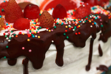 A fragment of the texture of an assorted cake with chocolate, protein cream, berries and marmalade