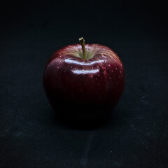A red apple on a dark background
