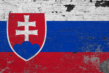 Fototapeta premium Slovakia flag on grunge scratched concrete surface. National vintage background. Retro wall concept.