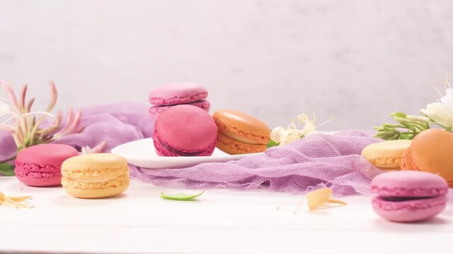 A french sweet delicacy, macaroons variety closeup. Color fresh macarroons on wooden bacground