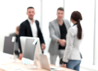 blurry image of employees at their workplace in the office.