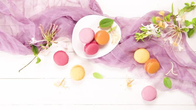 A french sweet delicacy, macaroons variety closeup. Color fresh macarroons on wooden bacground