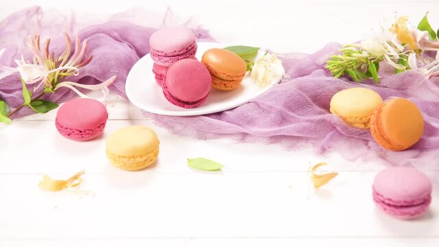 A french sweet delicacy, macaroons variety closeup. Color fresh macarroons on wooden bacground