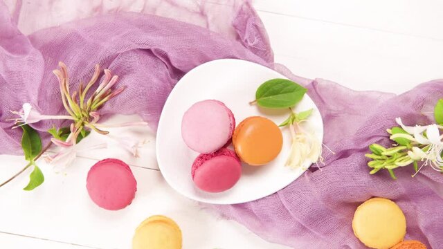 A french sweet delicacy, macaroons variety closeup. Color fresh macarroons on wooden bacground
