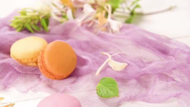 A french sweet delicacy, macaroons variety closeup. Color fresh macarroons on wooden bacground