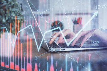 Double exposure of woman hands typing on computer and forex chart hologram drawing. Stock market invest concept.