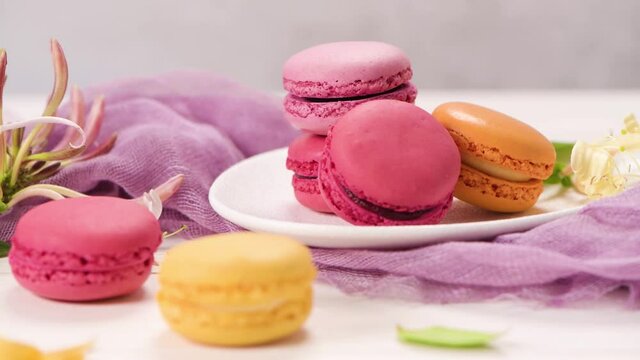 A french sweet delicacy, macaroons variety closeup. Color fresh macarroons on wooden bacground