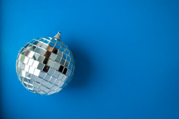 Christmas composition. Christmas wooden decorations and tinsel on a blue  background. Flat layout, top view, space for text.