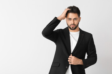 Handsome man with stylish hairdo on white background