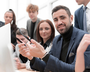 project Manager and business team sitting at the Desk