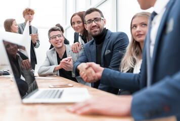 business partners shaking hands at the office Desk