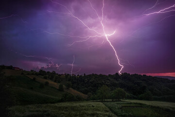 Fototapeta na wymiar thunder lightning in the night over forest