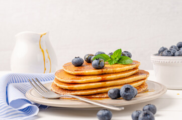 Stack of pancakes with fresh blueberry and caramel syrup