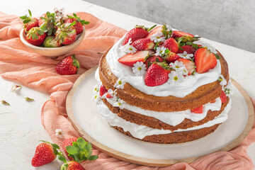 Strawberry cake, strawberry sponge cake with fresh strawberries and sour cream on a white background