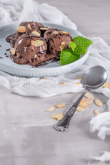 Delicious chocolate ice cream for dessert on plate with mint leaf