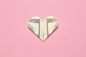 Origami heart made of dollar banknote on color background