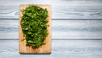 Fresh bright green spinach on a wooden cutting board. Dietary nutrition. Top view, selective focus