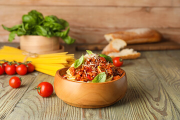 Bowl with tasty pasta bolognese on table
