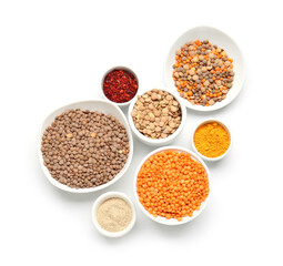 Bowls with lentils and spices on white background
