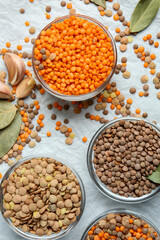 Bowls with lentils on color background
