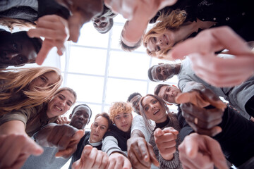 close up . many odiverse young people are pointing at you