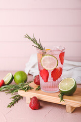 Glass of fresh strawberry lemonade on table
