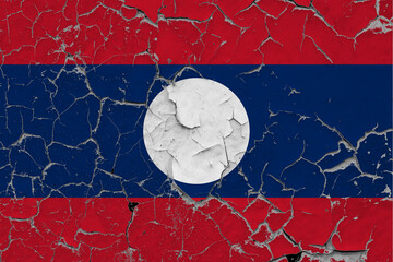 Laos flag close up grungy, damaged and scratched on wall peeling off paint to see inside surface. Vintage National Concept.
