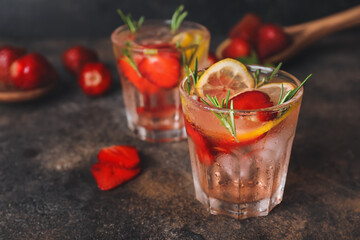 Glasses of fresh strawberry lemonade on table