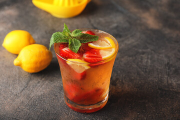 Glass of fresh strawberry lemonade on table