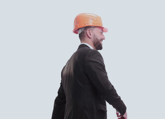 side view.smiling businessman in a helmet going forward