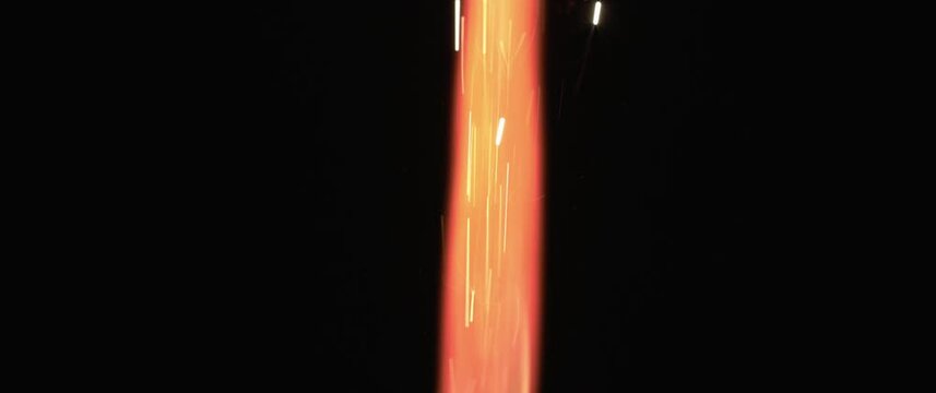 Red and orange sparks coming out of a firework. Holiday, celebration, new year, christmas, birthday concept. Shallow DOF, close up, BMPCC 4K