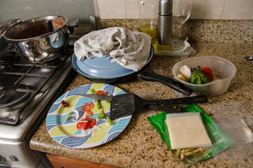 Kitchen in mess with food waste and dishes