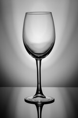 Transparent glass stands on black glass, backlit