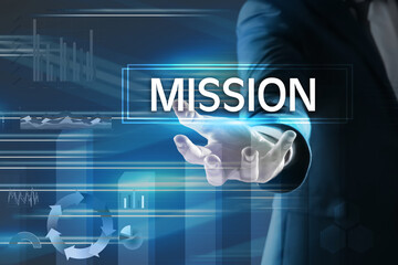 Mission concept. Businessman demonstrating word and charts on background