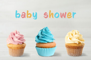 Delicious cupcakes for baby shower party on light background'