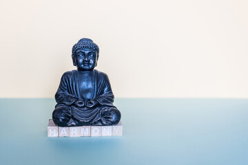 with wooden stamps the word harmony is formed below the buddha figure