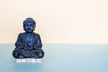 with wooden stamps the word quiet is formed below the buddha figure