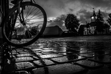 Night rainy city. Paving stones. Wet streets. Bike at sunset. The world is wonderful. Background.