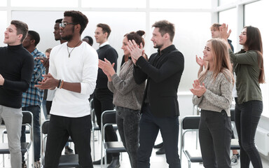 group of diverse young people applauding together.