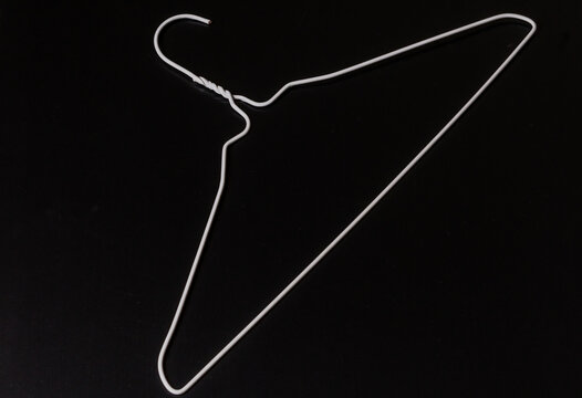 A Single Silver Wire Hanger On A White Background Stock Photo