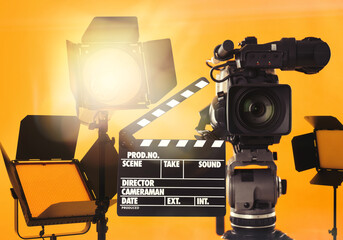 Modern professional video camera and lighting equipment in studio