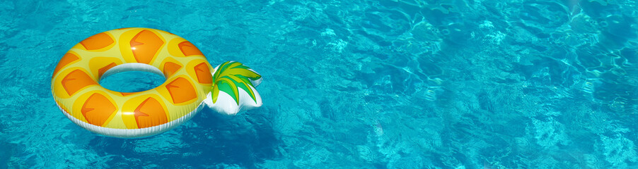 Bright inflatable pineapple ring floating in swimming pool on sunny day, space for text. Banner...
