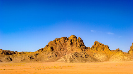 Fototapeta na wymiar It's Wadi Rum, The Valley of the Moon, a valley cut into the sandstone and granite rock in southern Jordan.