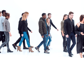 group of diverse young people walking in one direction