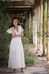 Beautiful young woman wears a long white dress