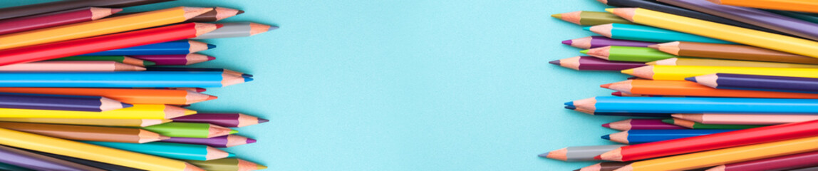 Palette kit of multi colored pencils on green background. Space for text, back to school. Sketching and drawing hobby. Stationery supply store banner